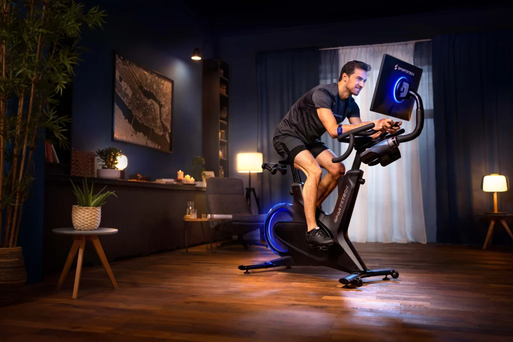 the Sportsech sBike is pictured in a living room with a man using it