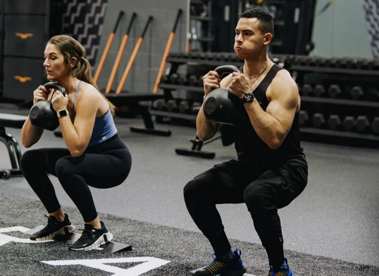 an image of two LA Fitness members working out