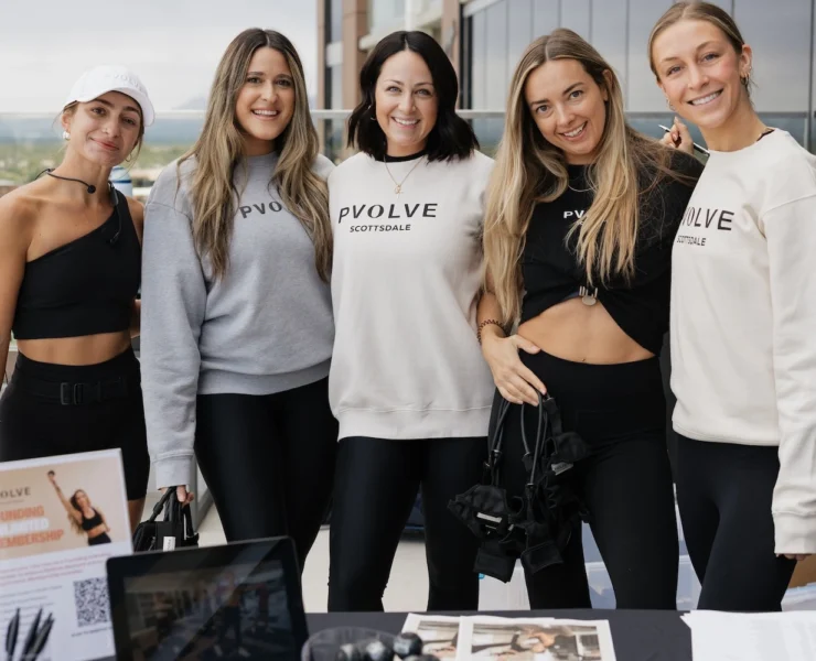 women in Pvolve clothing smile for a group photo