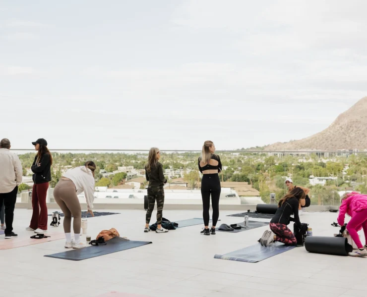 women work out overlooking mountains