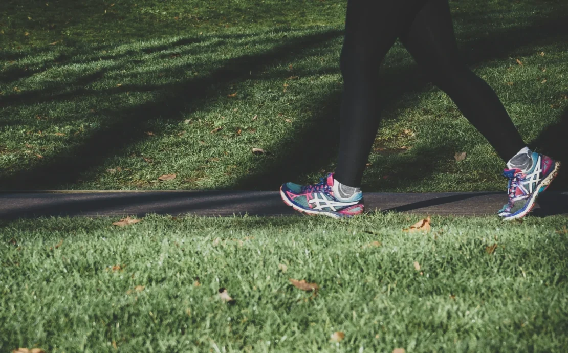 person walking on grass