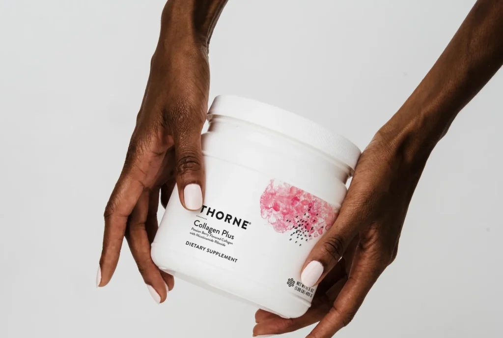 woman holds a collagen supplement container