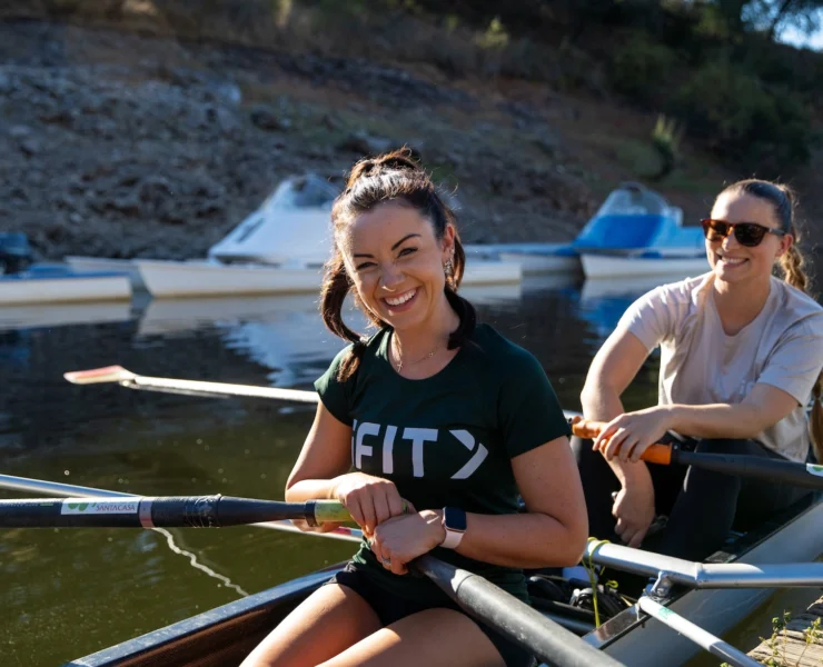 woman rows wearing an iFIT shirt