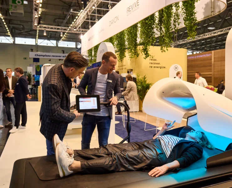 Person trying wellness equipment at trade show