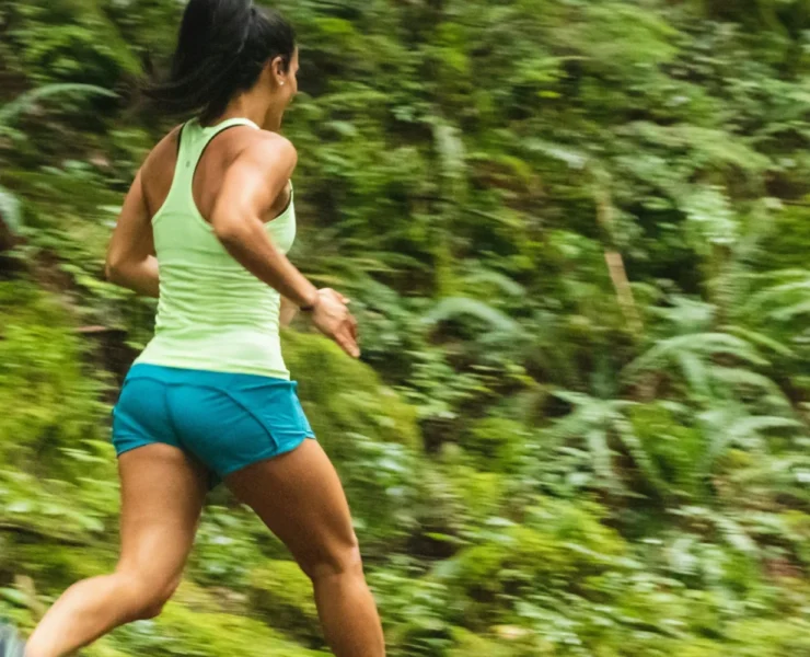 a woman running alone on a trail outdoors