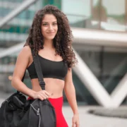 Young woman with gym bag