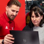 man showing woman how to use fitness app