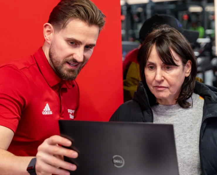 man showing woman how to use fitness app