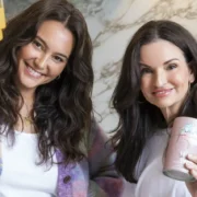 Make Time Wellness founders in a kitchen holding their products.