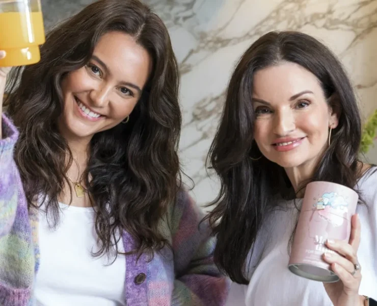 Make Time Wellness founders in a kitchen holding their products.
