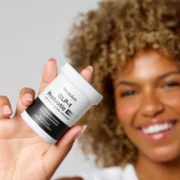 Black woman holding a bottle of GLP-1 from Pendulum