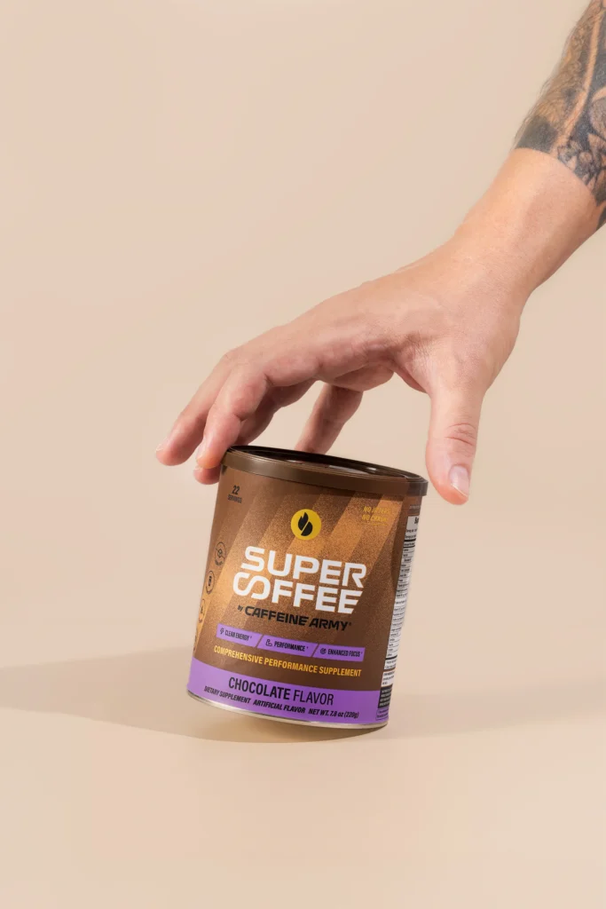 hand grabs a bottle of Caffeine Army coffee