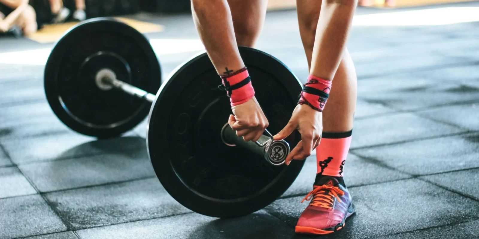 a woman securing weights / strength training