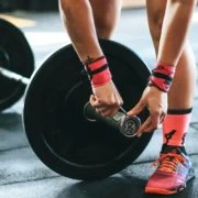 a woman securing weights / strength training