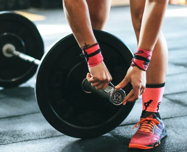 a woman securing weights / strength training